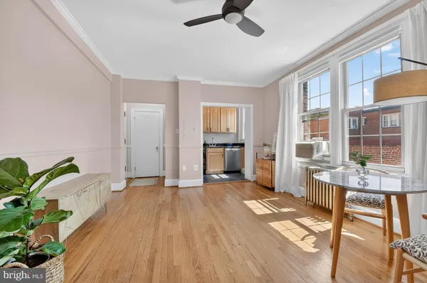a view of empty room with a window and wooden floor