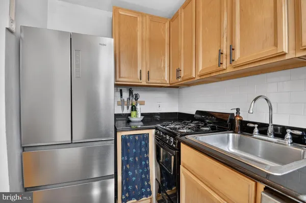 a kitchen with stainless steel appliances granite countertop a refrigerator sink and cabinets