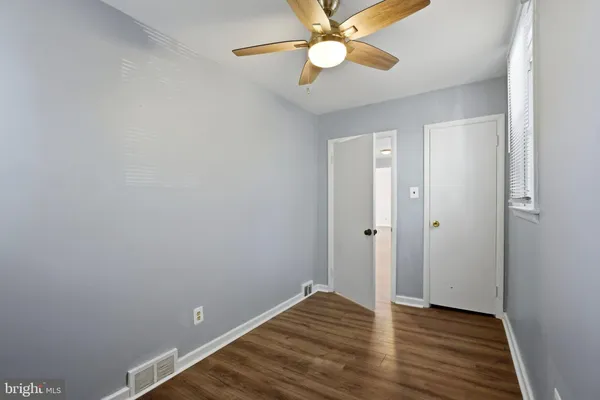 a view of an empty room with wooden floor