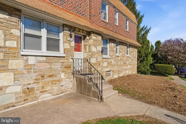 a view of a brick house with many windows