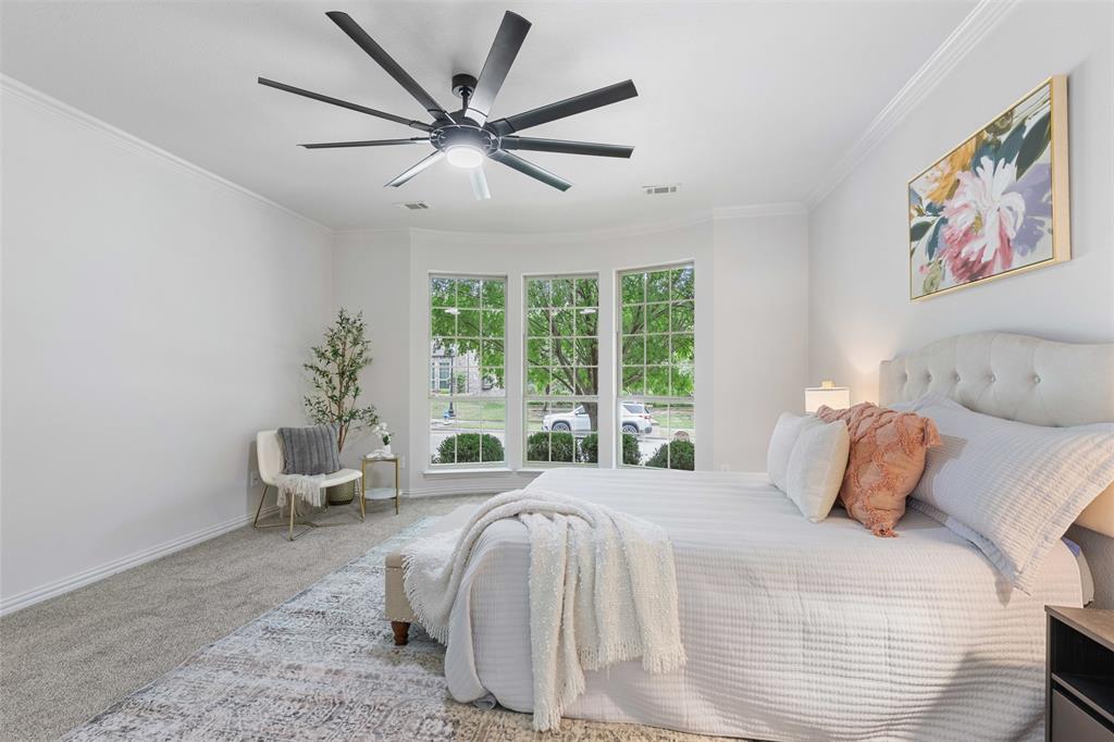 11984 Del Rio Drive Frisco, TX 75035 - Photo 15 of 38 a bedroom with a large bed and a chandelier