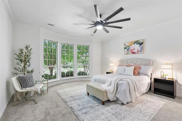 a spacious bedroom with a large bed and a couch
