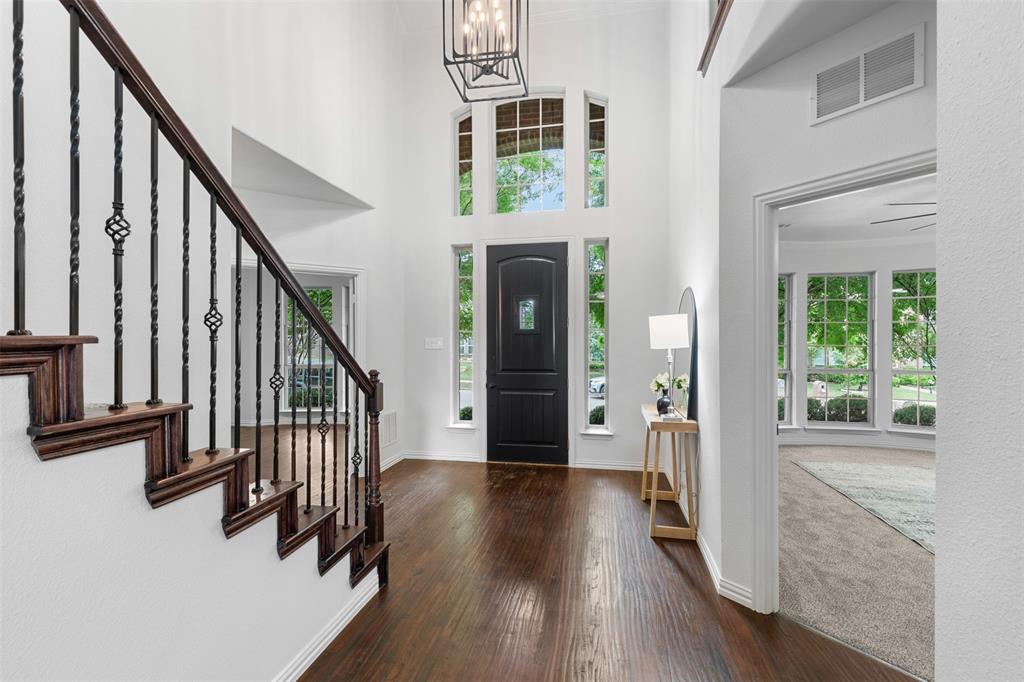 11984 Del Rio Drive Frisco, TX 75035 - Photo 3 of 38 a view of a hallway with wooden floor and staircase