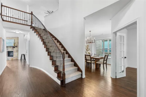 a view of staircase with wooden floor and a chandelier