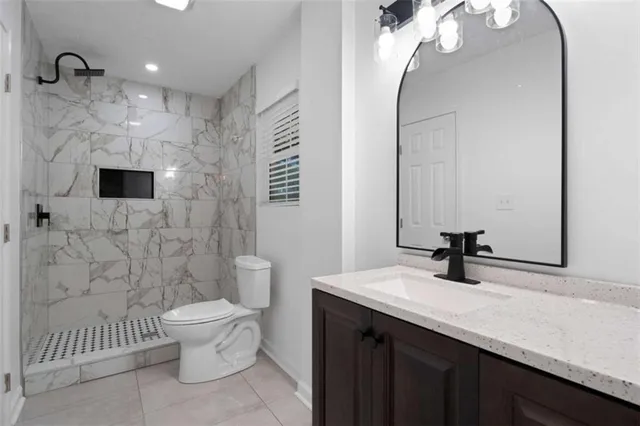 a bathroom with a sink a toilet and a mirror