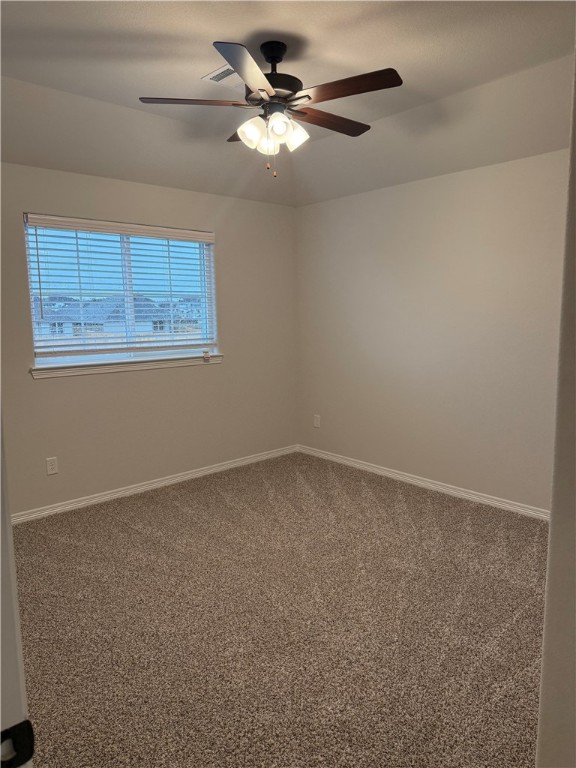 6308 Raleigh Drive College Station, TX 77845 - Photo 13 of 19 Carpeted empty room featuring baseboards and a ceiling fan