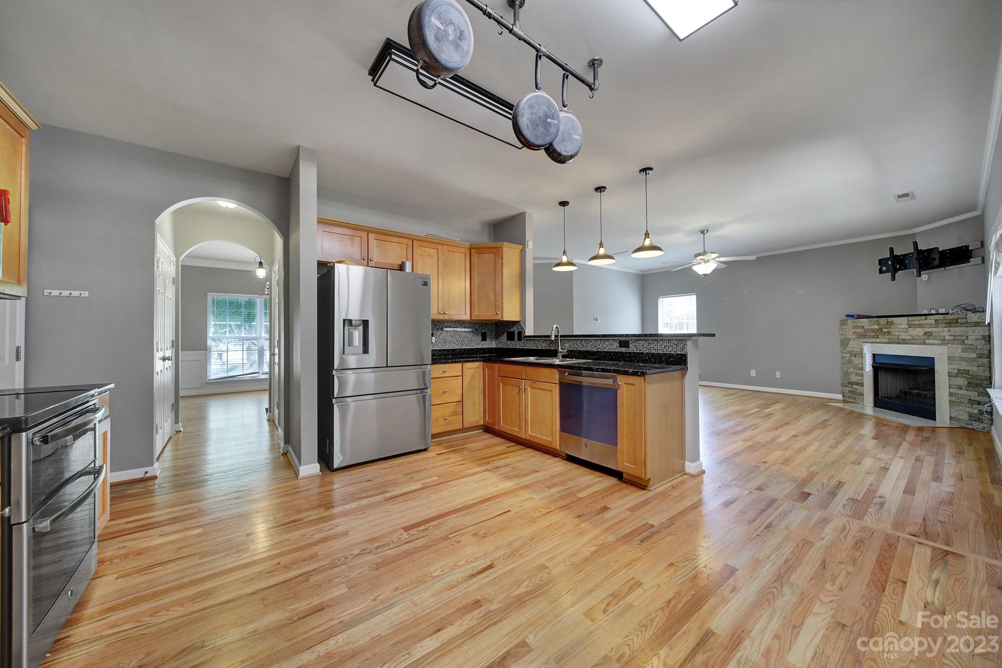 7224 Cascading Pines Drive Tega Cay, SC 29708 - Photo 11 of 36 a kitchen with granite countertop a refrigerator and a stove top oven