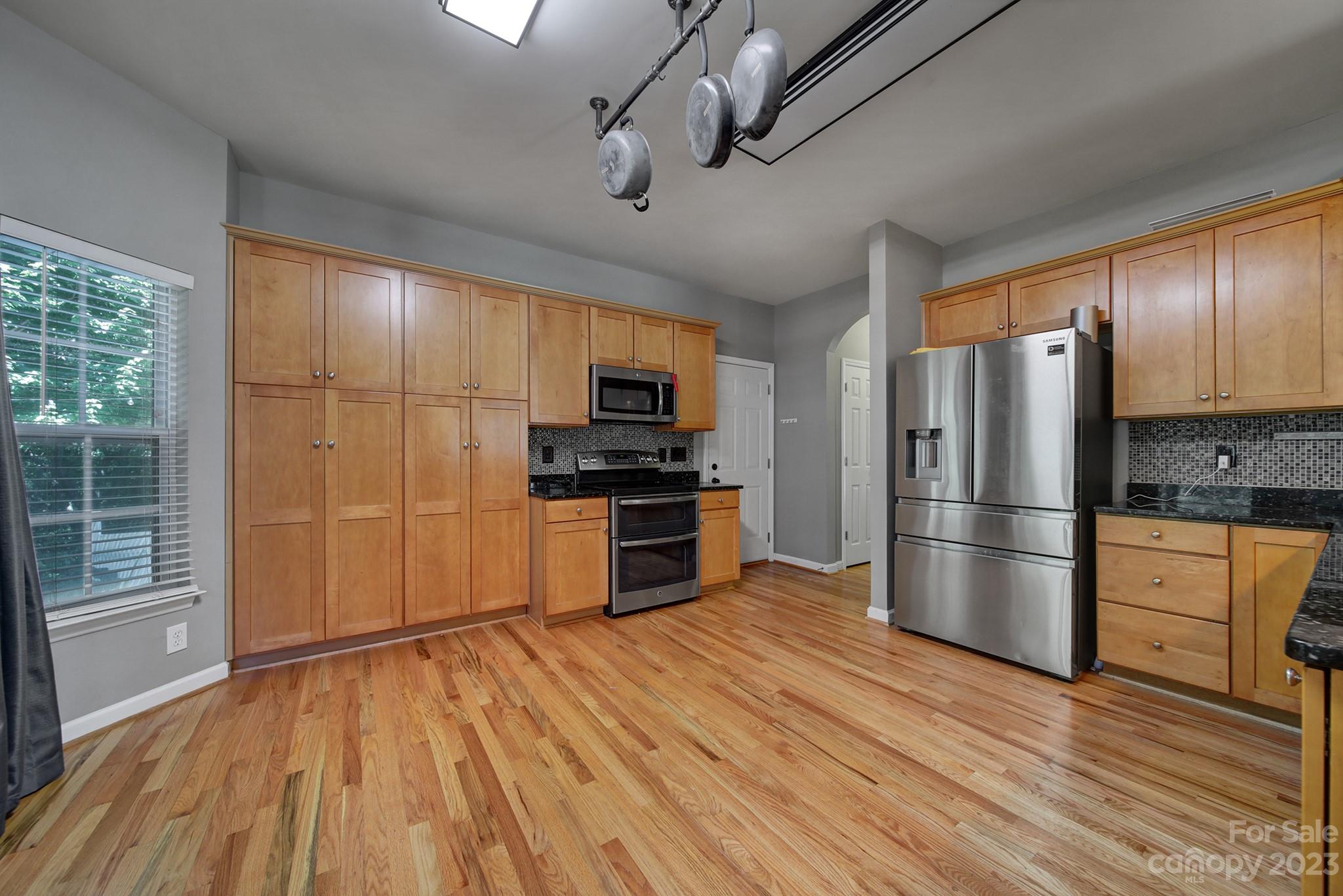 7224 Cascading Pines Drive Tega Cay, SC 29708 - Photo 13 of 36 a kitchen with stainless steel appliances a refrigerator and a stove top oven