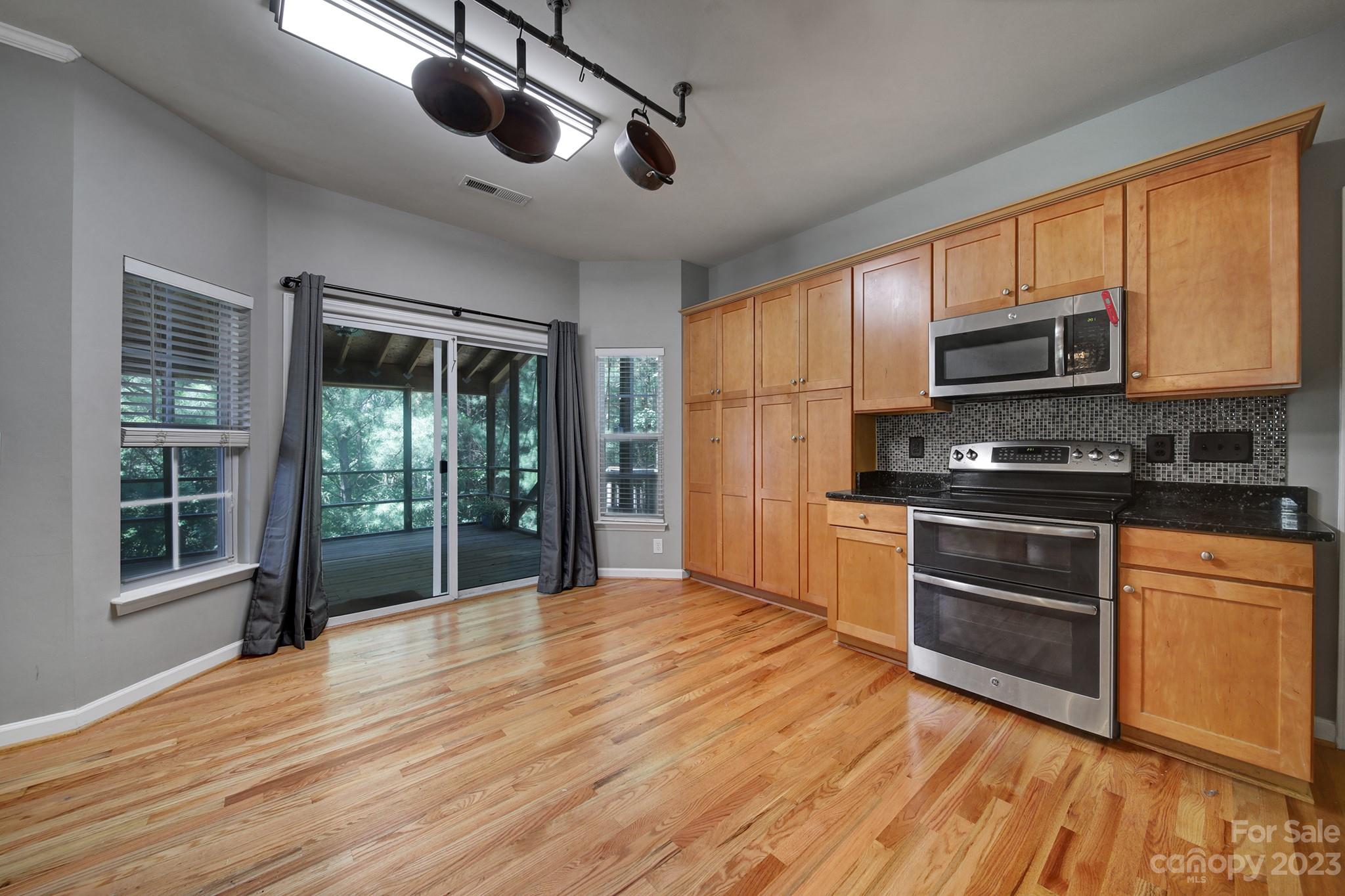 7224 Cascading Pines Drive Tega Cay, SC 29708 - Photo 14 of 36 a kitchen with stainless steel appliances granite countertop a stove a refrigerator and a microwave oven
