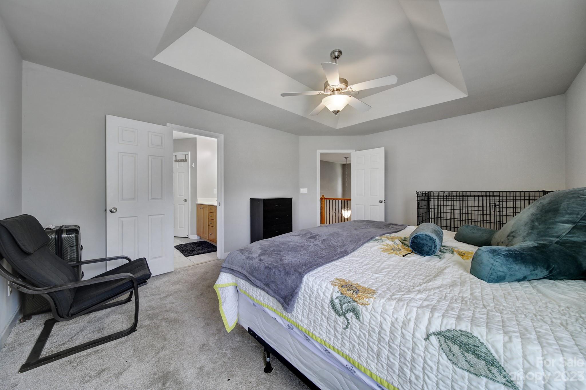 7224 Cascading Pines Drive Tega Cay, SC 29708 - Photo 20 of 36 a bedroom with a bed and a chandelier