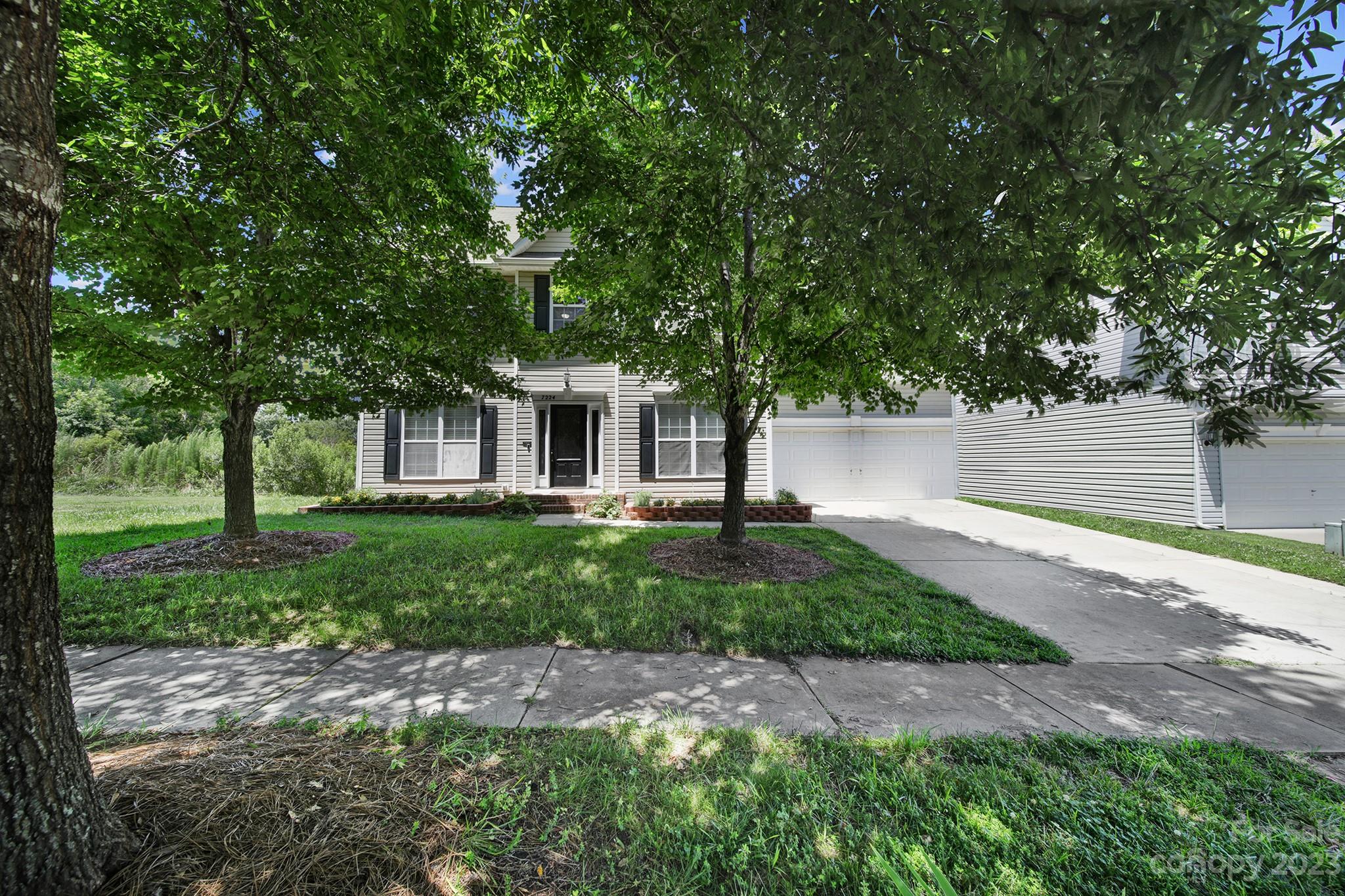 7224 Cascading Pines Drive Tega Cay, SC 29708 - Photo 2 of 36 a front view of a house with garden