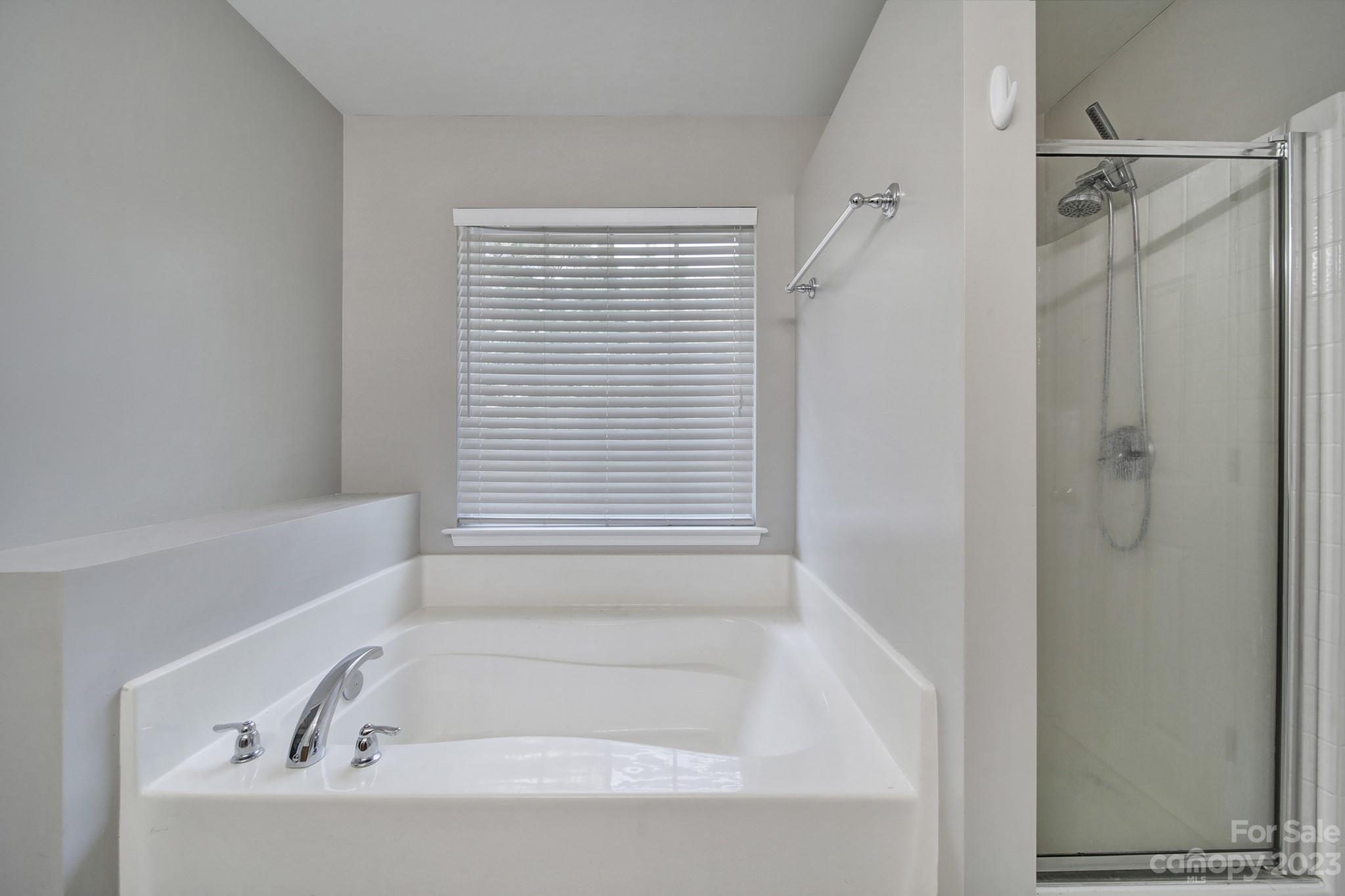 7224 Cascading Pines Drive Tega Cay, SC 29708 - Photo 21 of 36 a bathroom with a bathtub and a shower