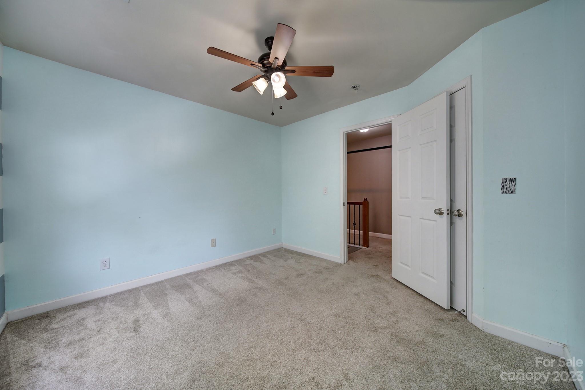 7224 Cascading Pines Drive Tega Cay, SC 29708 - Photo 23 of 36 a view of an empty room with chandelier fan