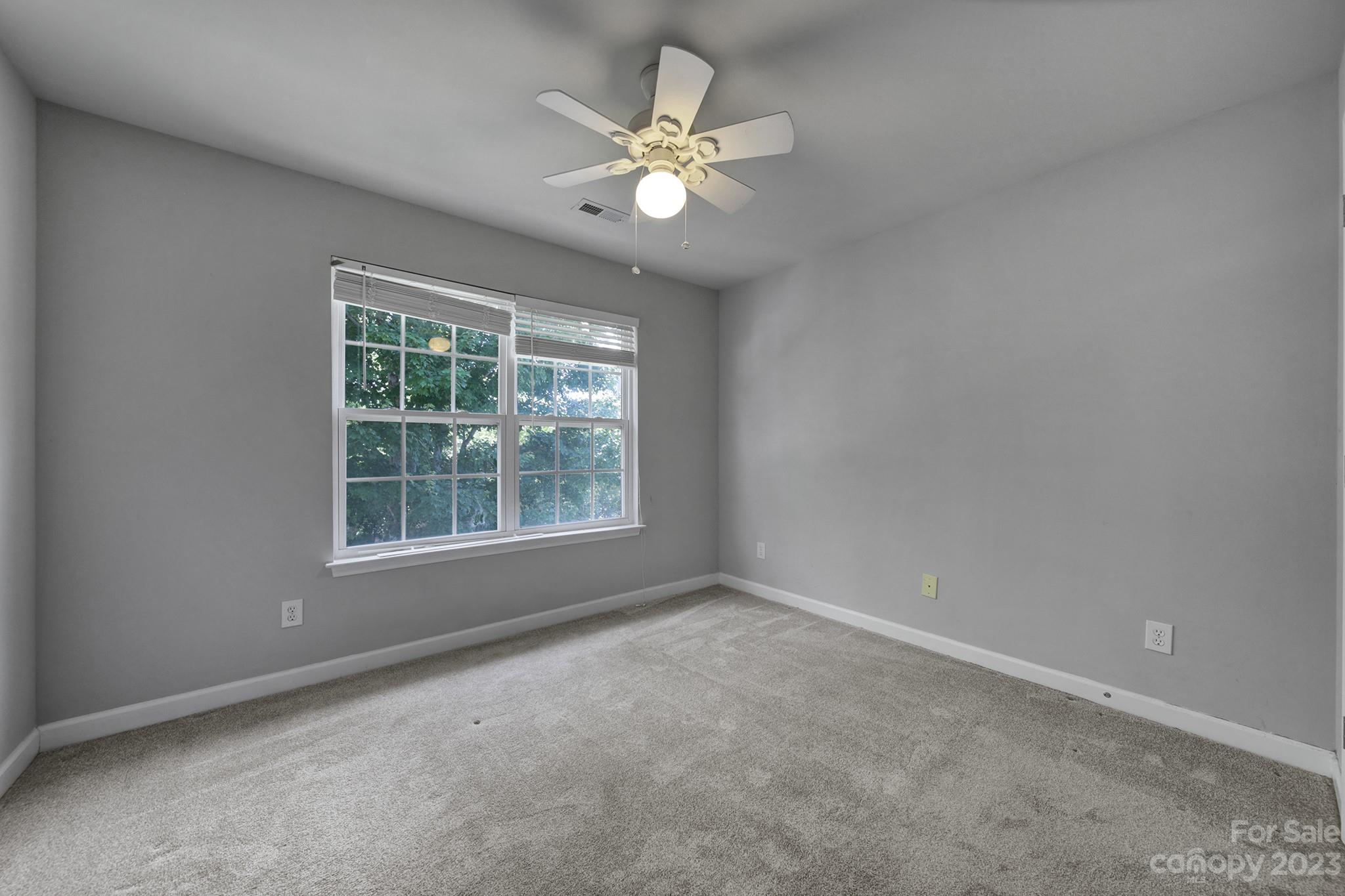 7224 Cascading Pines Drive Tega Cay, SC 29708 - Photo 26 of 36 an empty room with a window and a ceiling fan