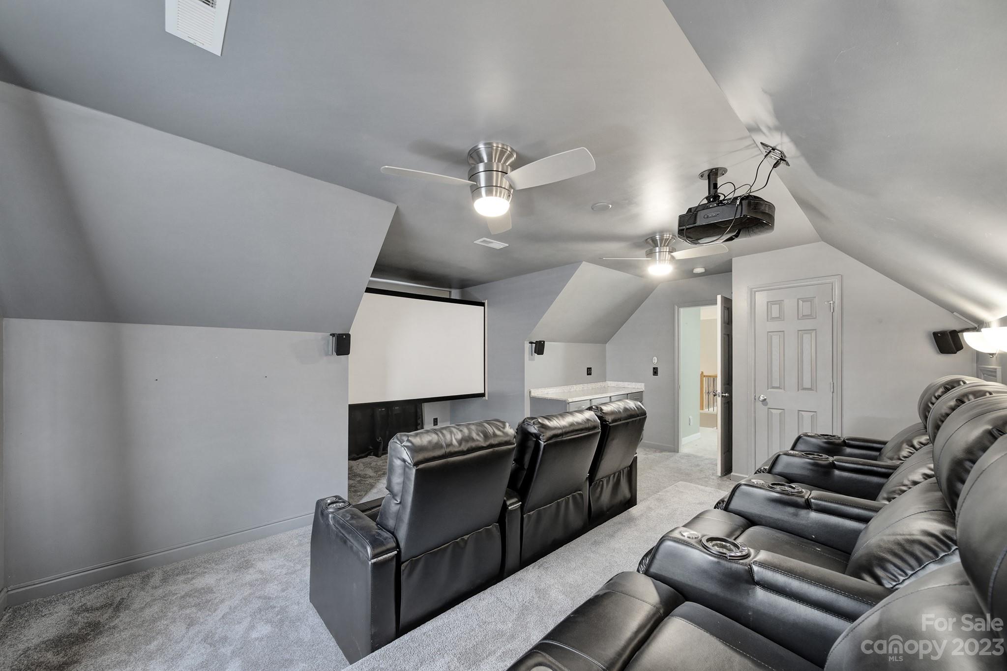 7224 Cascading Pines Drive Tega Cay, SC 29708 - Photo 29 of 36 a living room with furniture kitchen area and a ceiling fan