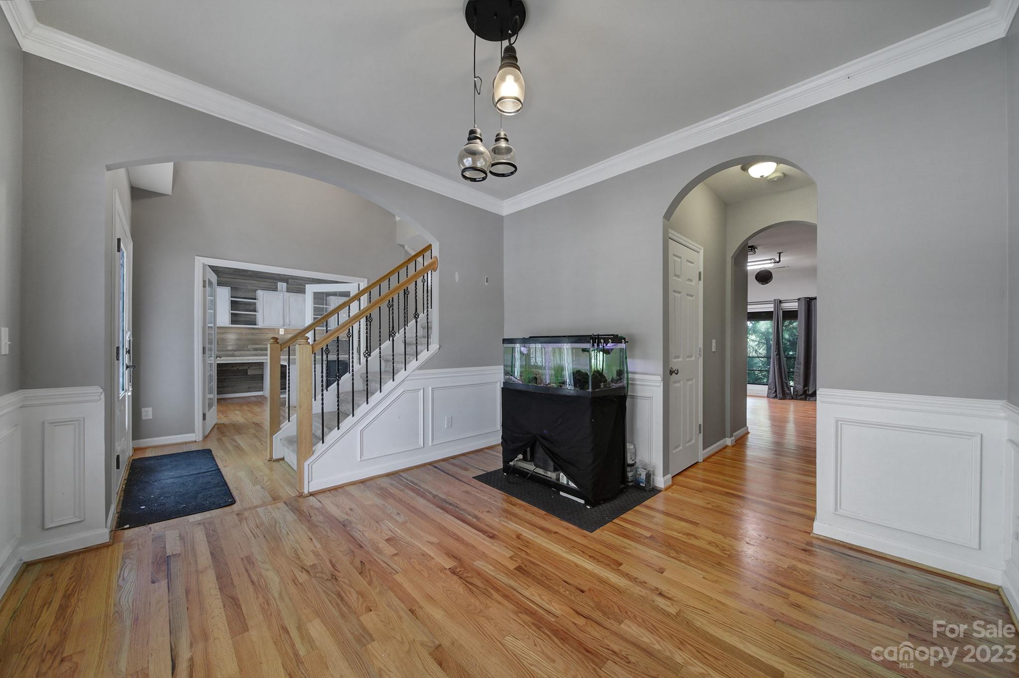 7224 Cascading Pines Drive Tega Cay, SC 29708 - Photo 6 of 36 a view of a livingroom with wooden floor and a chandelier