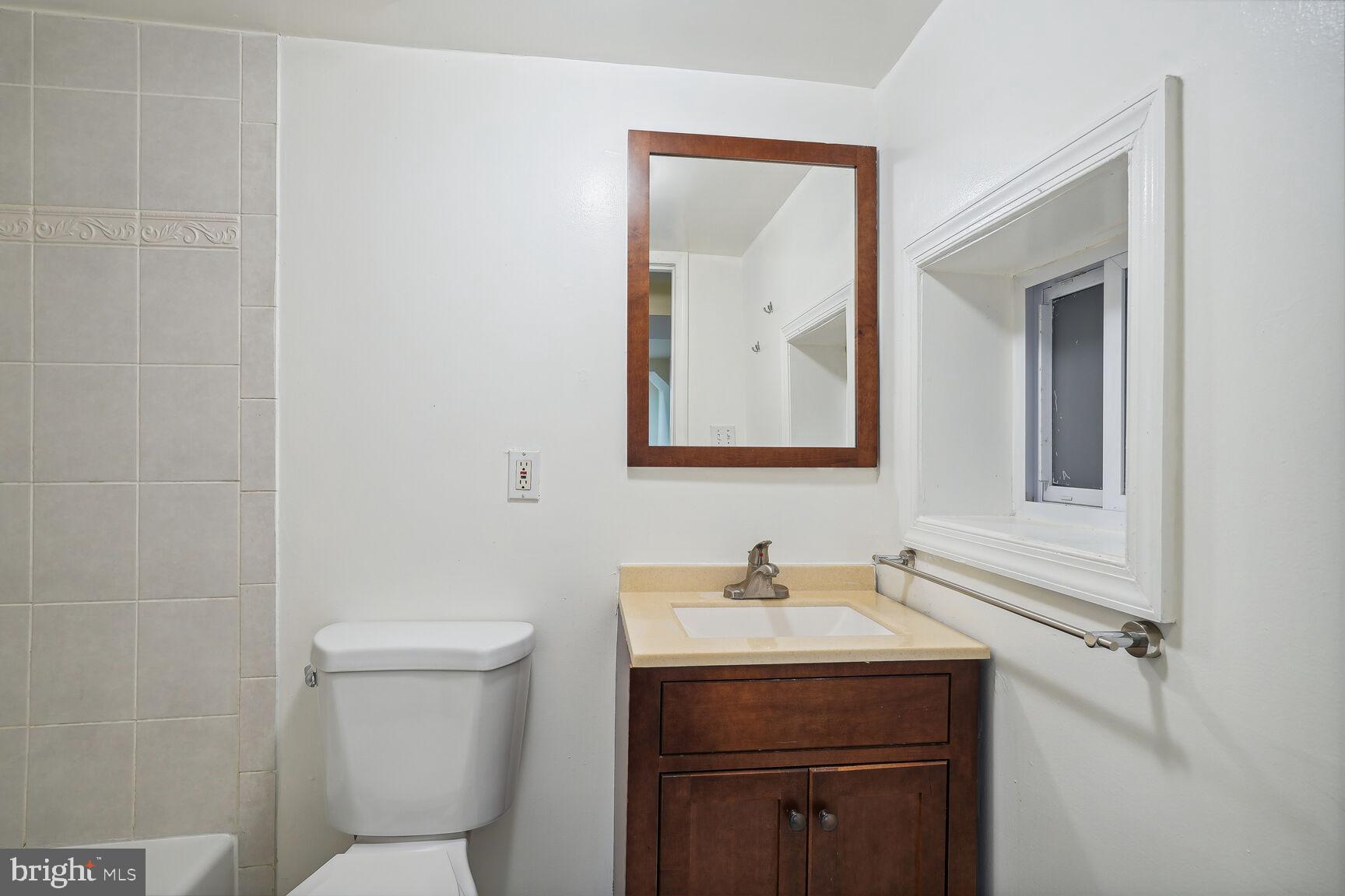 4528 4th Street Northwest Washington, DC 20011 - Photo 24 of 28 a bathroom with a toilet sink and mirror