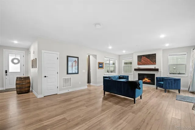 a living room with furniture and wooden floor