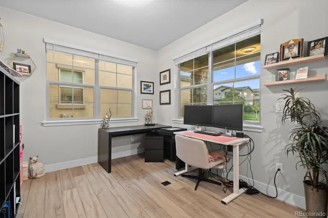 a workspace with furniture window and wooden floor