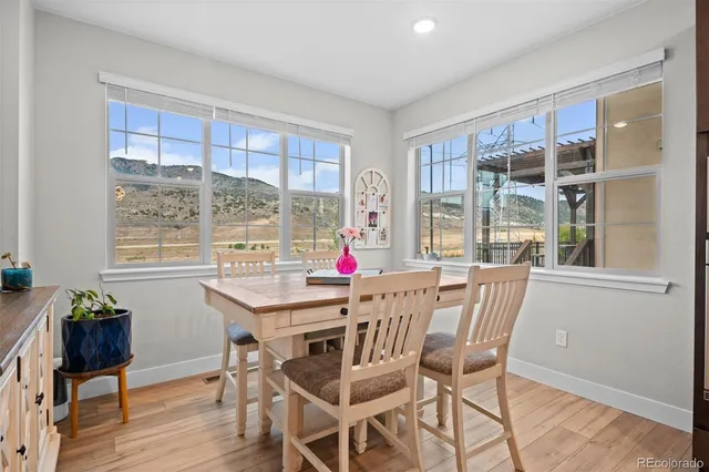 a view of a dining room with furniture window and wooden floor