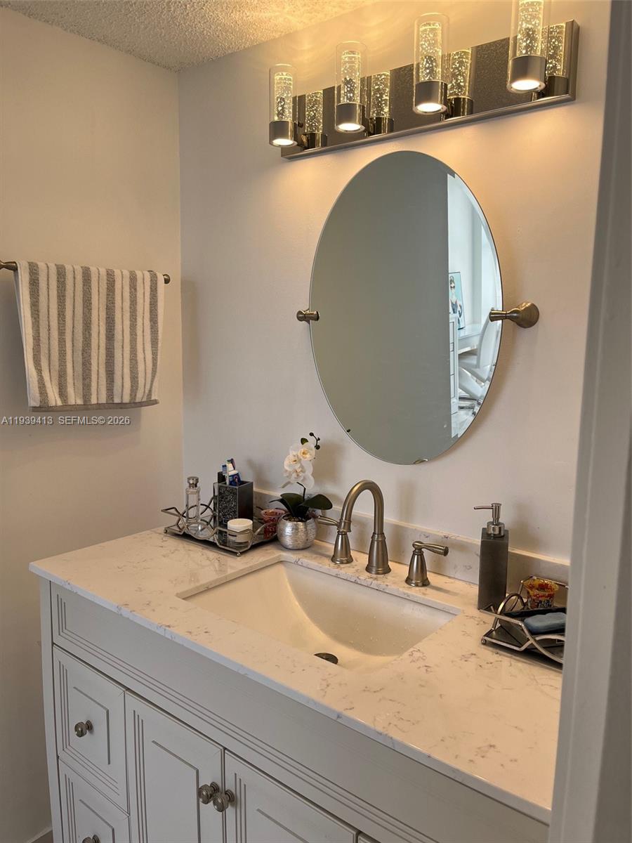 17021 North Bay Road, Unit 907 Sunny Isles Beach, FL 33160 - Photo 11 of 19 a bathroom with a sink and a mirror