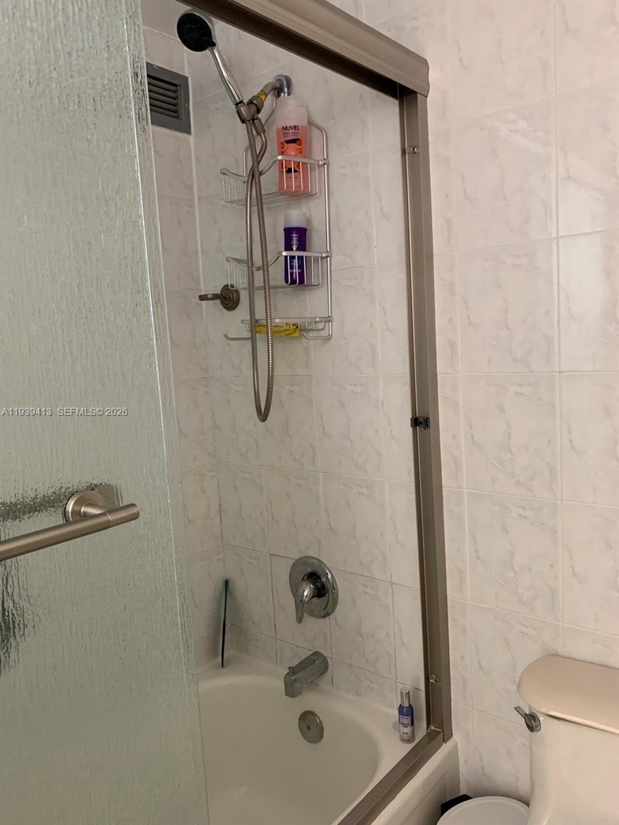 17021 North Bay Road, Unit 907 Sunny Isles Beach, FL 33160 - Photo 13 of 19 a bathroom with a shower and a toilet