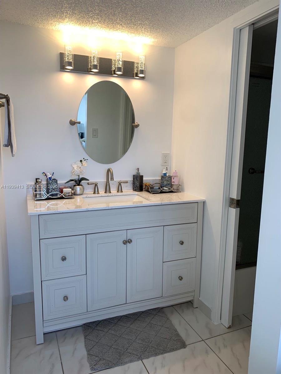 17021 North Bay Road, Unit 907 Sunny Isles Beach, FL 33160 - Photo 14 of 19 a bathroom with a double vanity sink and a mirror