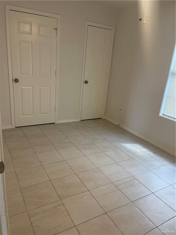 1408 Pine Street, Unit C Weslaco, TX 78596 - Photo 9 of 9 Unfurnished bedroom with light tile patterned floors