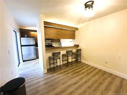 a view of a kitchen counter space and wooden floor