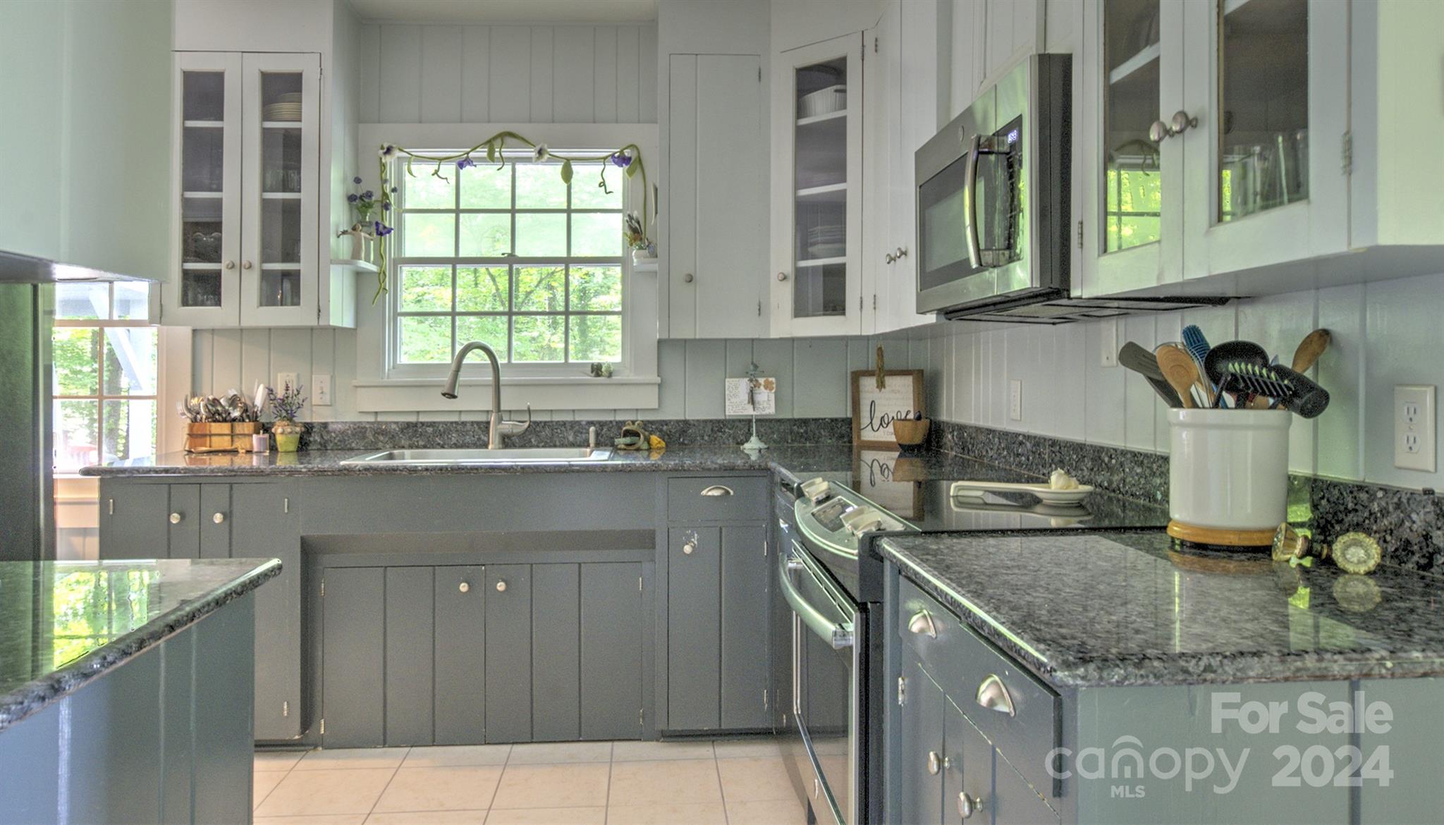 376 Page Farm Road Tryon, NC 28782 - Photo 8 of 34 a kitchen with stainless steel appliances granite countertop a sink a stove and a microwave