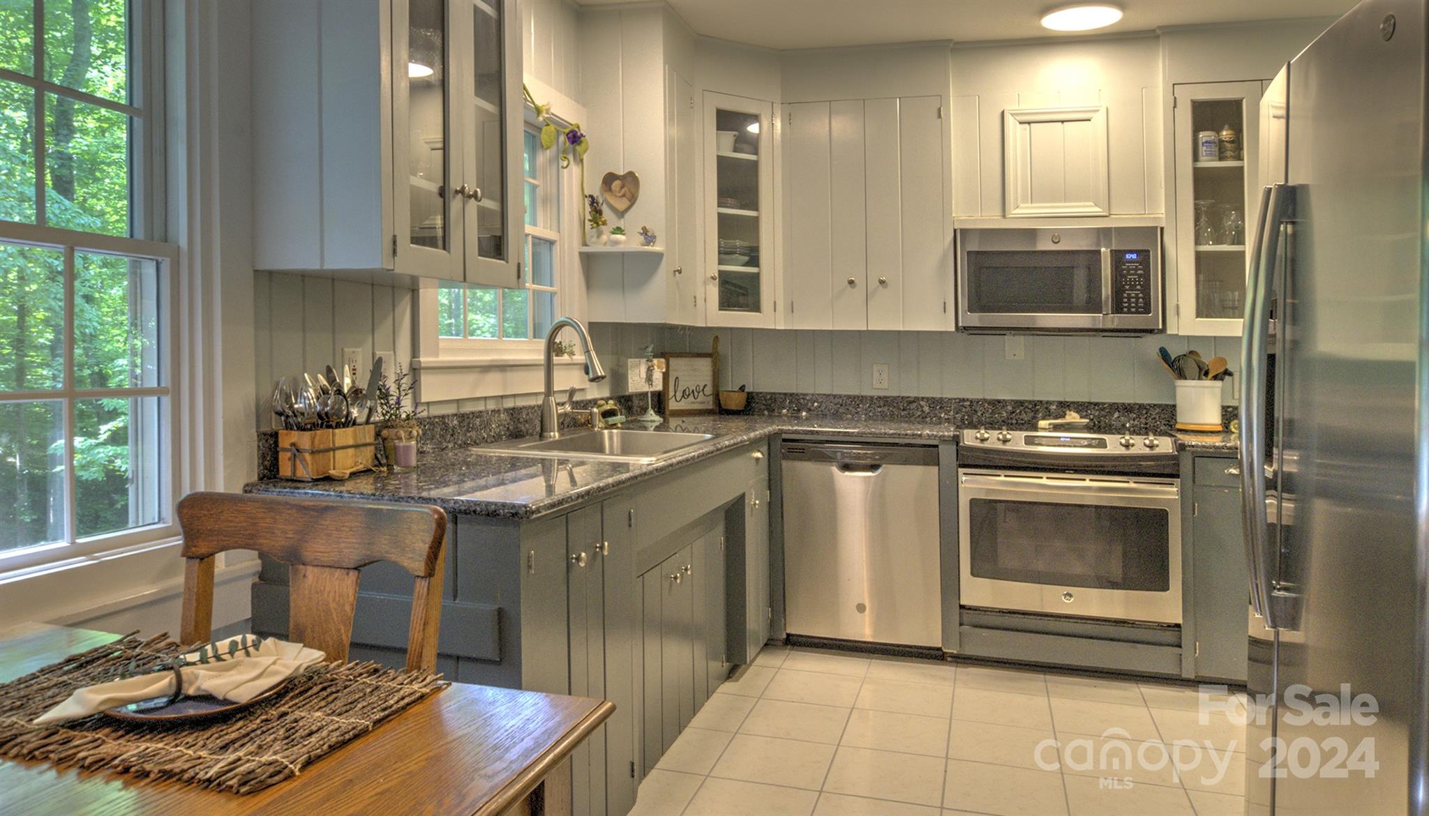 376 Page Farm Road Tryon, NC 28782 - Photo 10 of 34 a kitchen with stainless steel appliances granite countertop a sink stove and cabinets