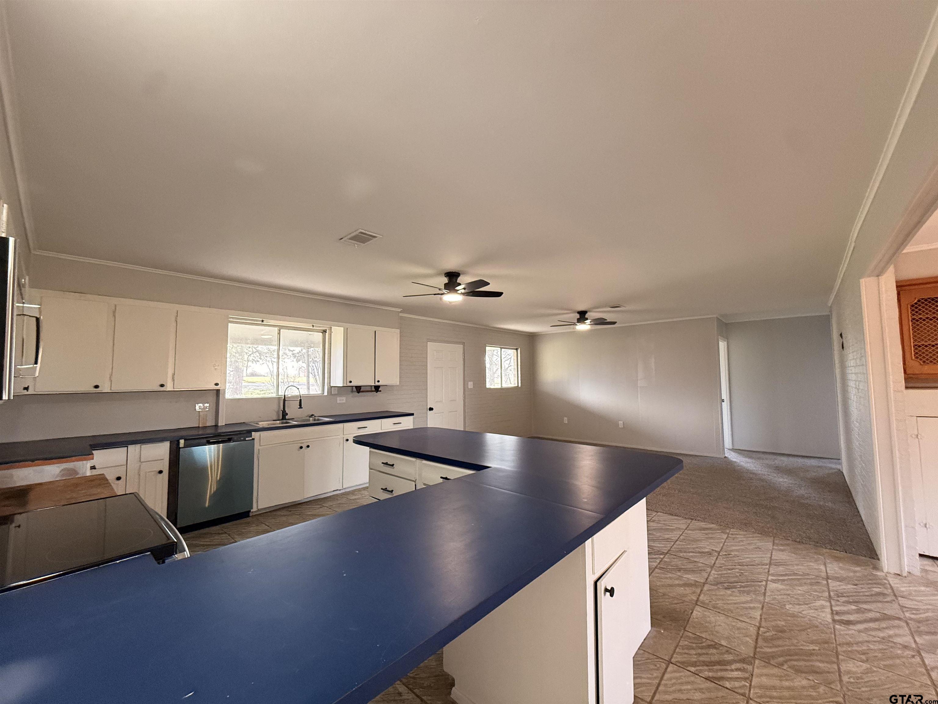 a view of a kitchen with a sink and cabinets