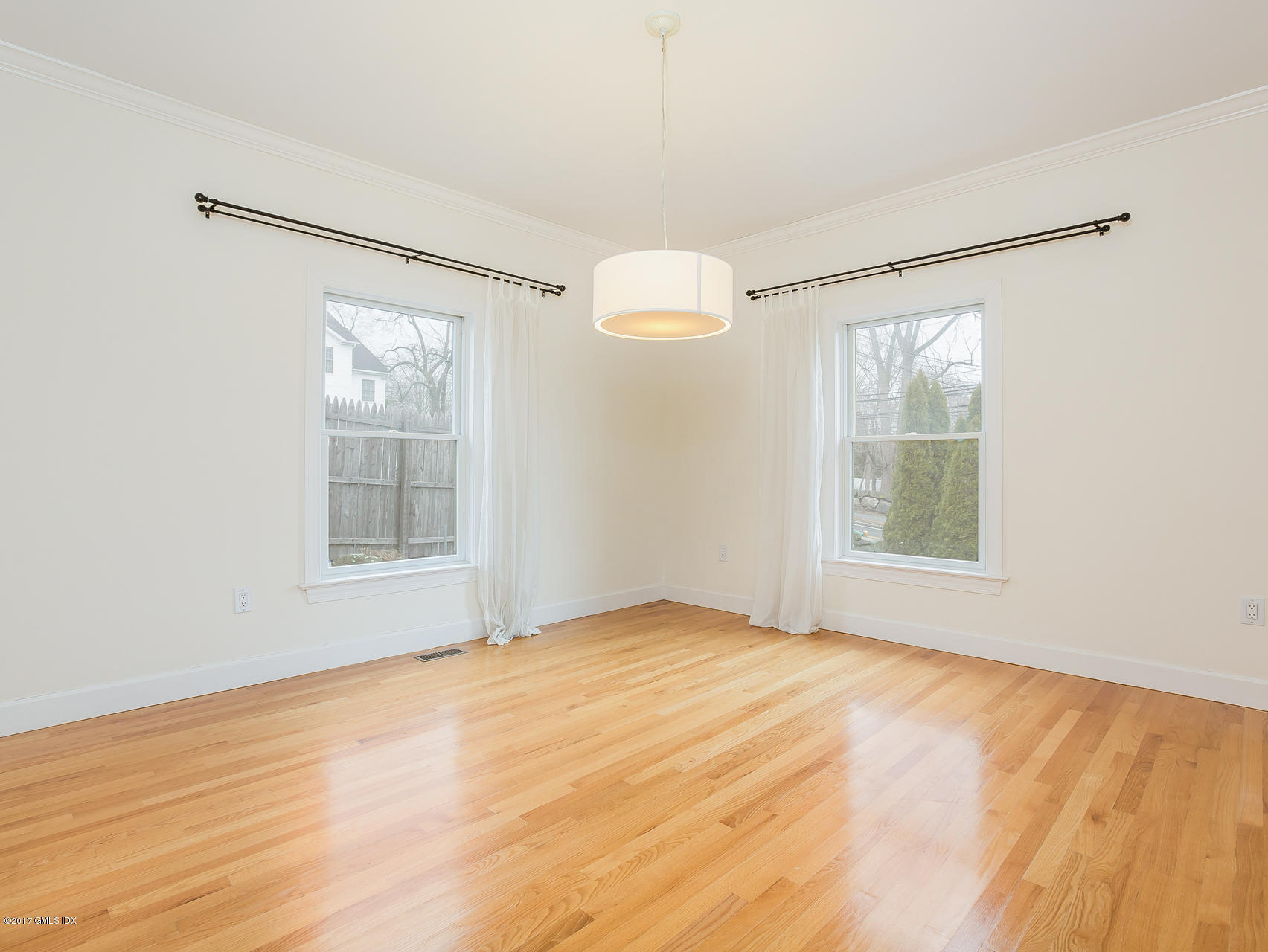 10 1/2 Sound Beach Ave Extension Riverside, CT 06878 - Photo 7 of 26 a view of an empty room with wooden floor and a window
