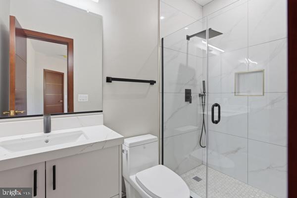 11701 Duckettown Road Bowie, MD 20720 - Photo 18 of 27 a bathroom with a sink a toilet and shower