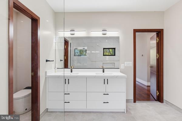 11701 Duckettown Road Bowie, MD 20720 - Photo 9 of 27 a bathroom with a sink a toilet and a mirror