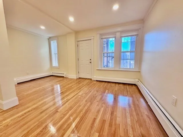 wooden floor in an empty room with a window