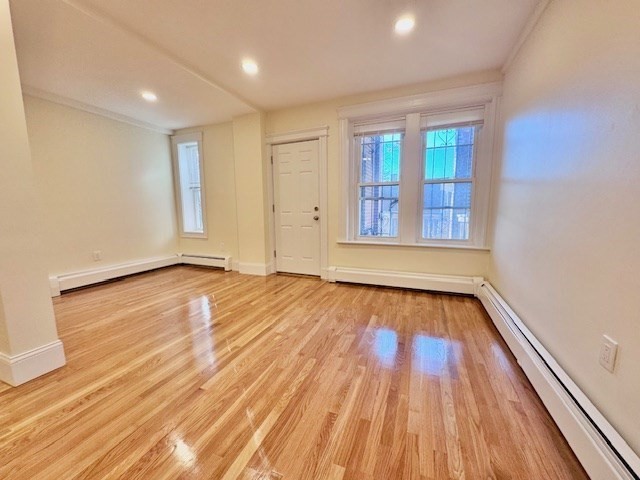 56 Cummings Road, Unit B Boston, MA 02135 - Photo 11 of 13 wooden floor in an empty room with a window