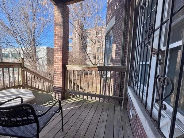 a view of a balcony with wooden floor