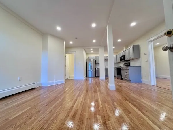 a view of a kitchen with wooden floor and a kitchen