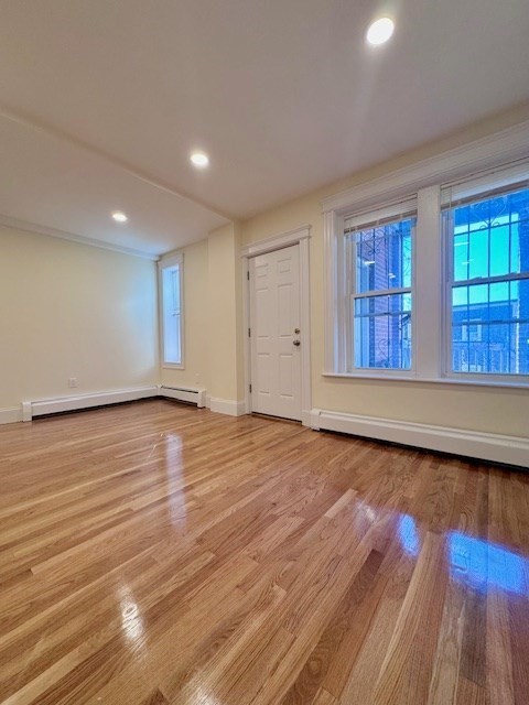 56 Cummings Road, Unit B Boston, MA 02135 - Photo 5 of 13 a view of an empty room with wooden floor and a window