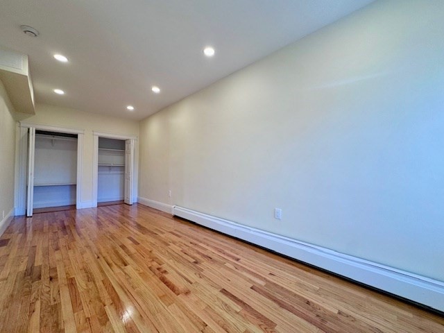 56 Cummings Road, Unit B Boston, MA 02135 - Photo 8 of 13 a view of an empty room and wooden floor