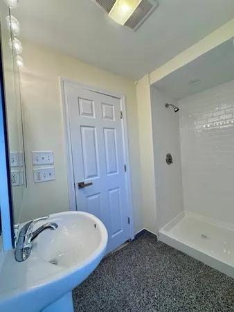 a bathroom with a tub and shower