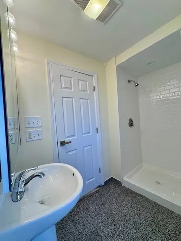 a bathroom with a tub and shower