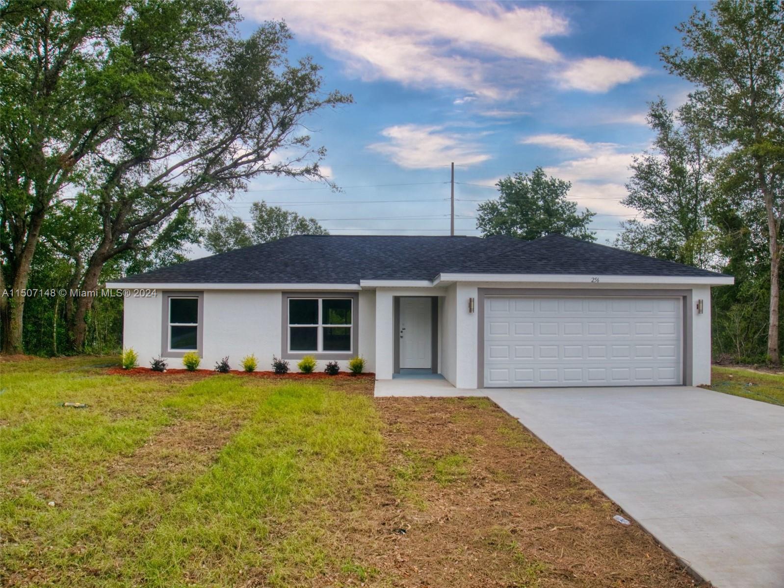 14512 Southwest 25th Lane Ocala, FL 34481 - Photo 1 of 30 front view of a house with a yard