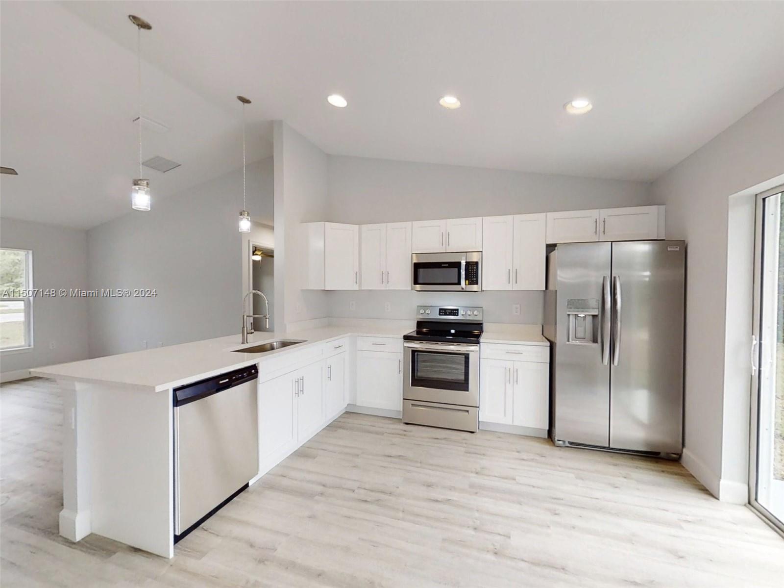 14512 Southwest 25th Lane Ocala, FL 34481 - Photo 11 of 30 a kitchen with cabinets and stainless steel appliances