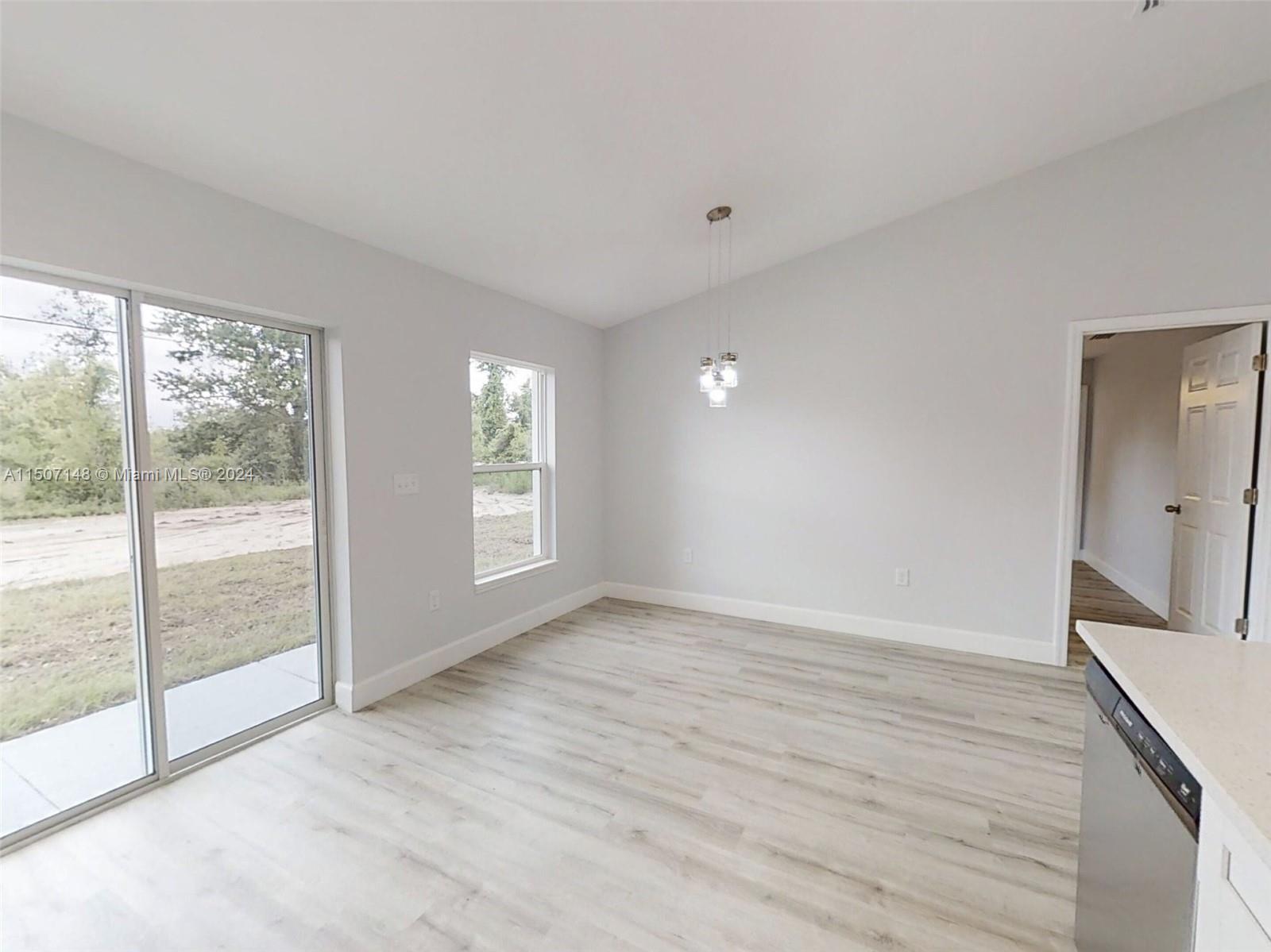 14512 Southwest 25th Lane Ocala, FL 34481 - Photo 12 of 30 a view of an empty room with wooden floor and a window