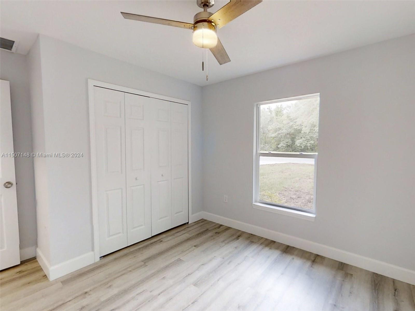 14512 Southwest 25th Lane Ocala, FL 34481 - Photo 15 of 30 wooden floor in an empty room with a window