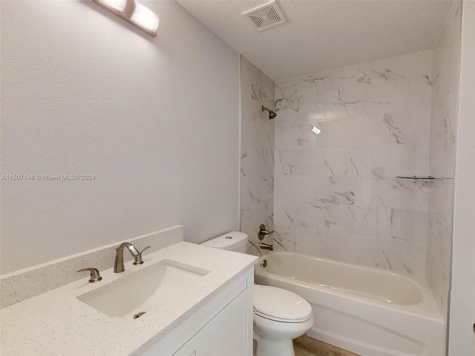14512 Southwest 25th Lane Ocala, FL 34481 - Photo 16 of 30 a bathroom with a bathtub shower sink mirror vanity and a toilet