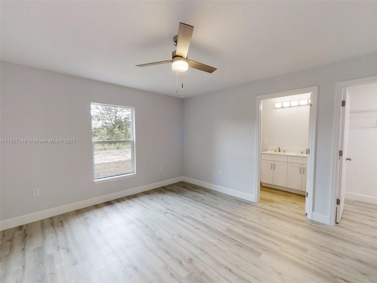 14512 Southwest 25th Lane Ocala, FL 34481 - Photo 21 of 30 wooden floor in an empty room with a window
