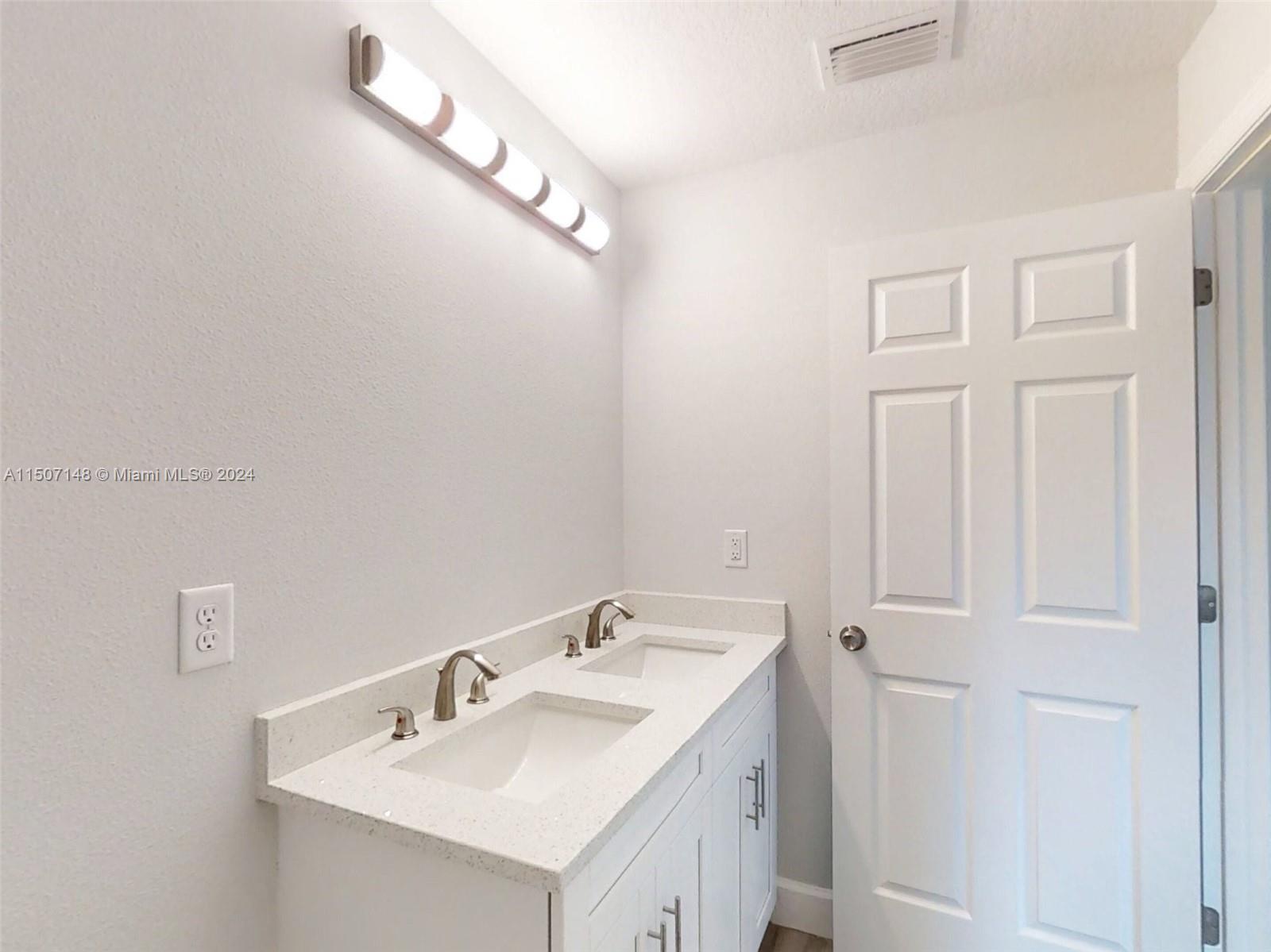 14512 Southwest 25th Lane Ocala, FL 34481 - Photo 26 of 30 a bathroom with a sink and a mirror